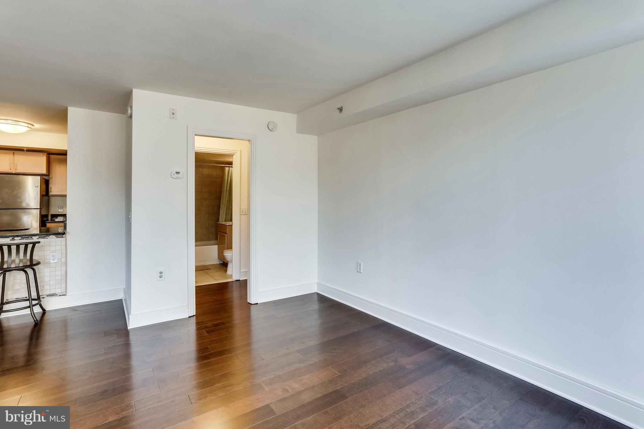800 4th Street Southwest, Unit N111 Washington, DC 20024 - Photo 27 of 35 a view of an empty room with wooden floor and a window