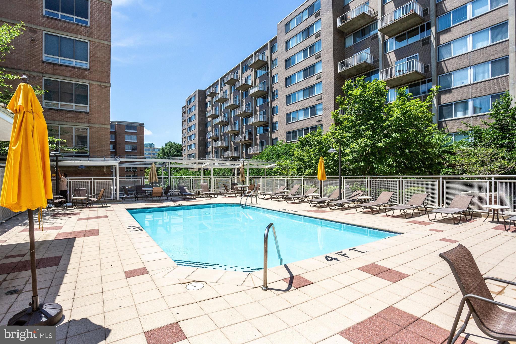 800 4th Street Southwest, Unit N111 Washington, DC 20024 - Photo 32 of 35 a view of a swimming pool with a lounge chairs