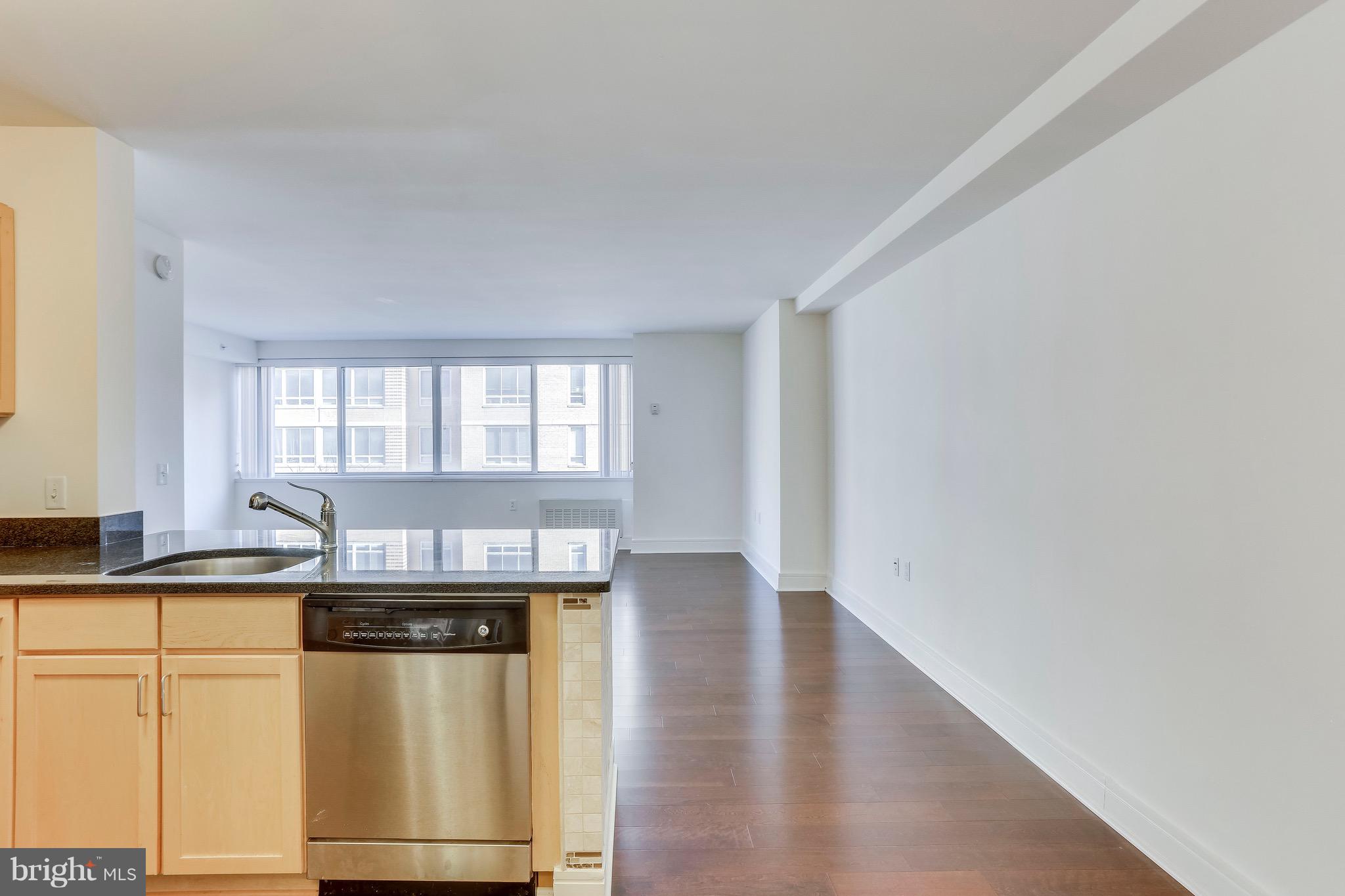 800 4th Street Southwest, Unit N111 Washington, DC 20024 - Photo 6 of 35 a room with stainless steel appliances wooden floor and a window