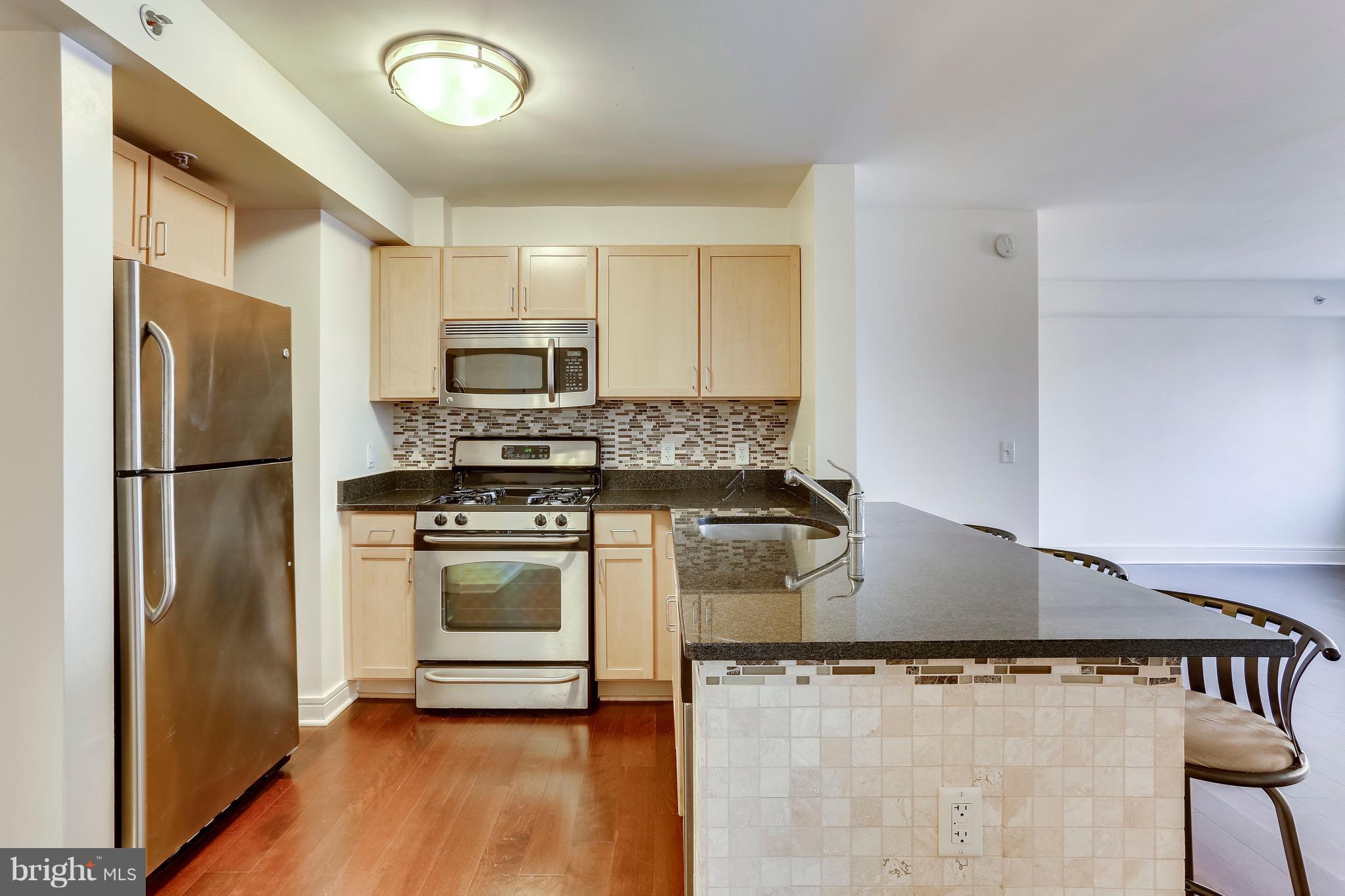 800 4th Street Southwest, Unit N111 Washington, DC 20024 - Photo 7 of 35 a kitchen with stainless steel appliances granite countertop a refrigerator a stove and a sink