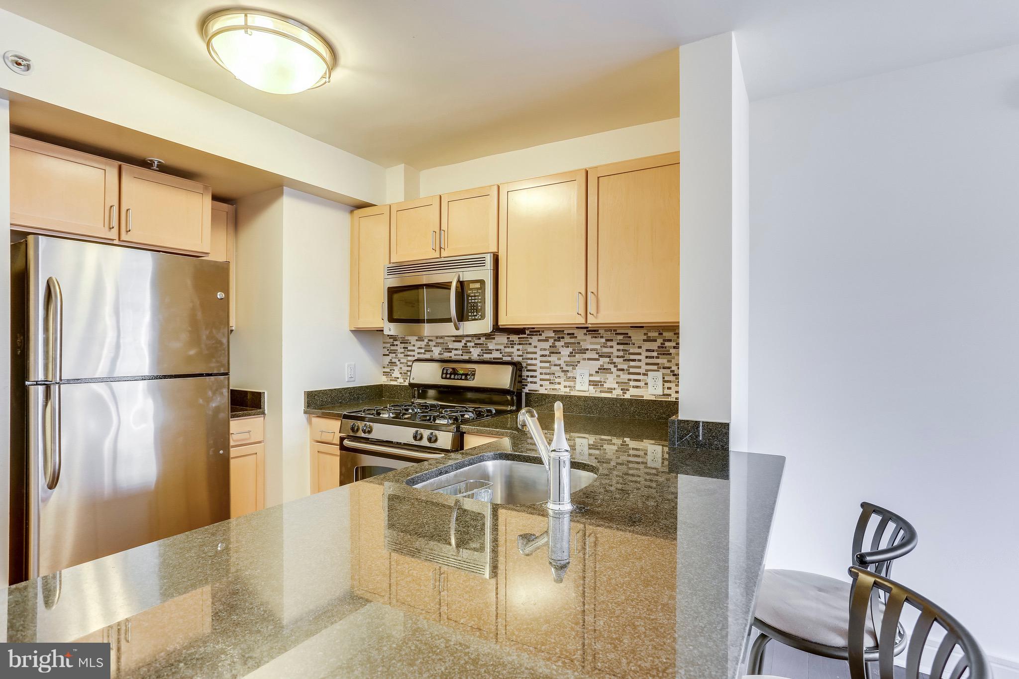 800 4th Street Southwest, Unit N111 Washington, DC 20024 - Photo 10 of 35 a kitchen with stainless steel appliances a refrigerator and a stove top oven