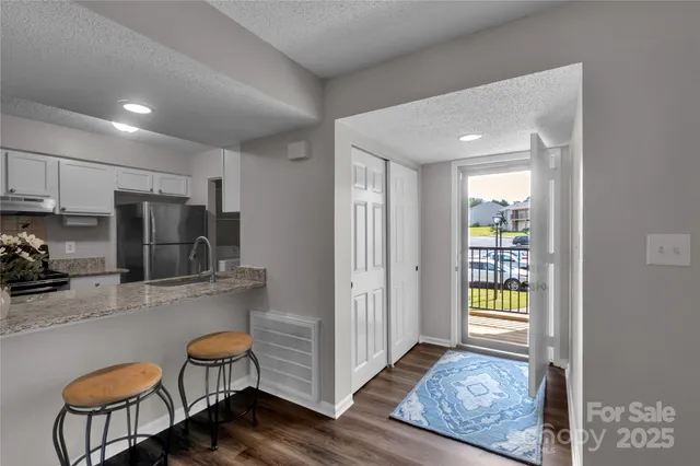 a kitchen with stainless steel appliances granite countertop a refrigerator and a stove top oven