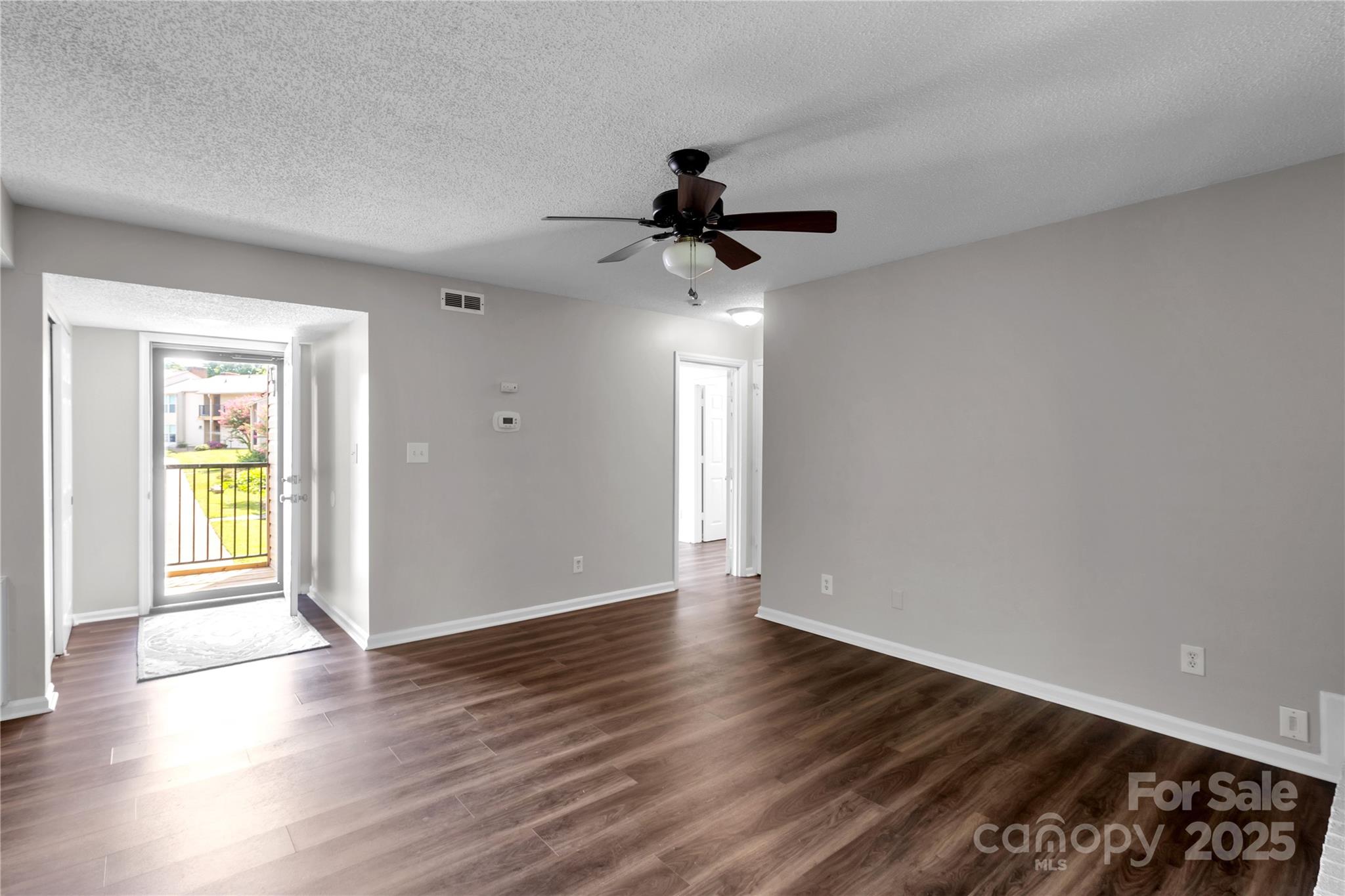 11014 Running Ridge Road Charlotte, NC 28226 - Photo 3 of 25 a view of an empty room with window and wooden floor