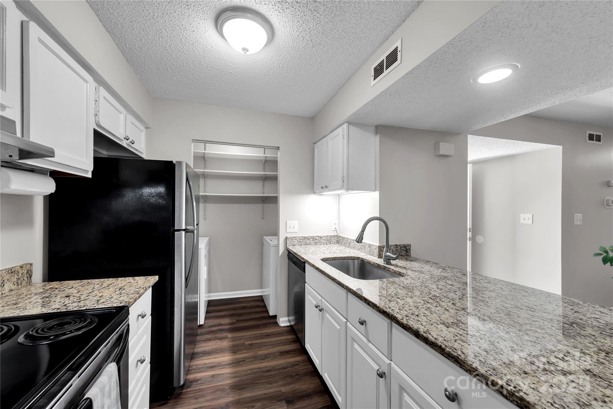11014 Running Ridge Road Charlotte, NC 28226 - Photo 6 of 25 a kitchen with granite countertop stainless steel appliances a sink and a refrigerator