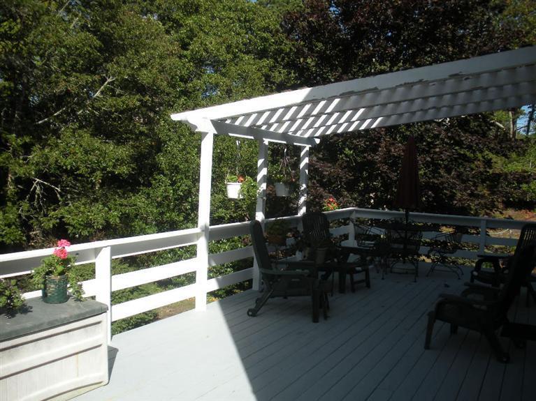 170 Ridgevale Road Chatham, MA 02633 - Photo 3 of 22 a patio with wooden floor a yard tables and chairs