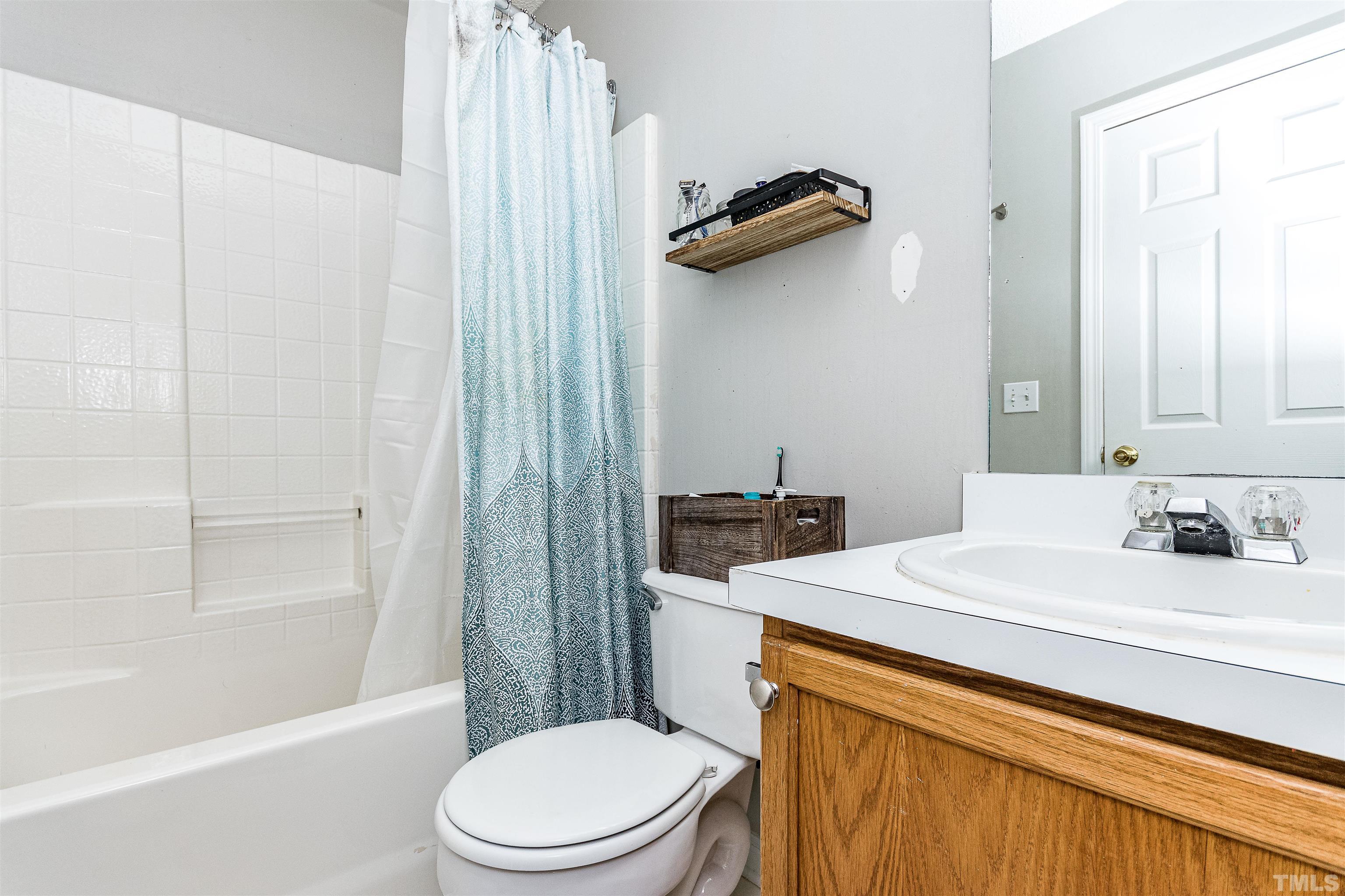 107 Ridge Lake Drive Apex, NC 27539 - Photo 16 of 27 a bathroom with a sink a toilet and shower