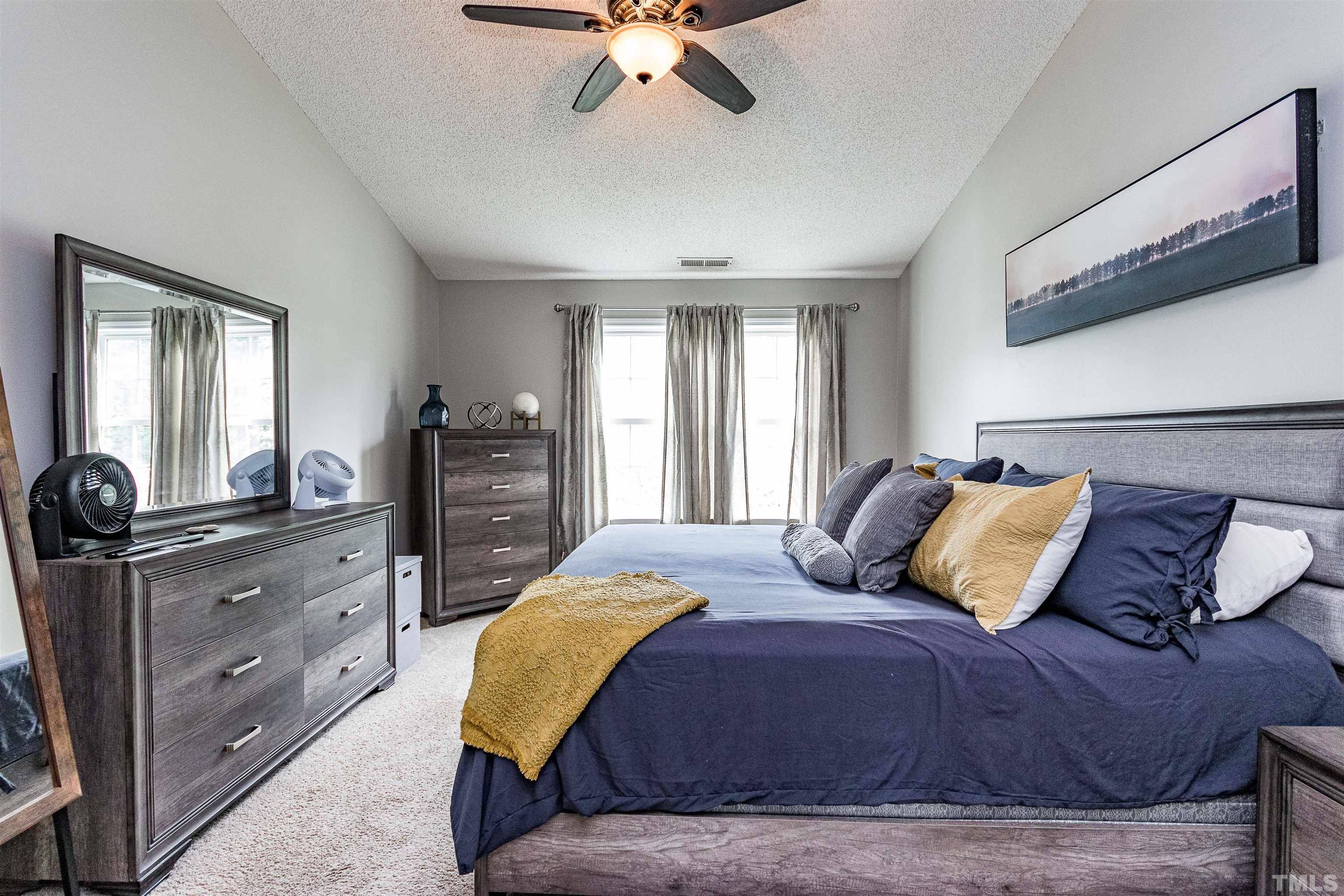 107 Ridge Lake Drive Apex, NC 27539 - Photo 18 of 27 a bedroom with a bed and wooden floor