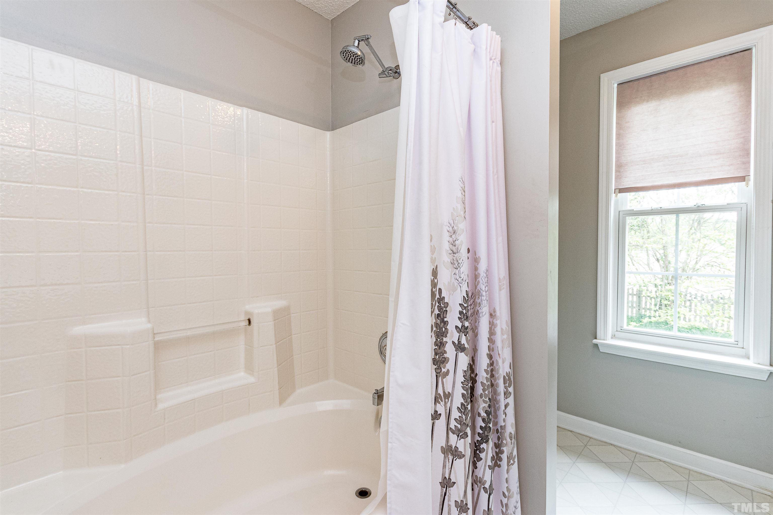 107 Ridge Lake Drive Apex, NC 27539 - Photo 20 of 27 a bathroom with a bathtub and shower