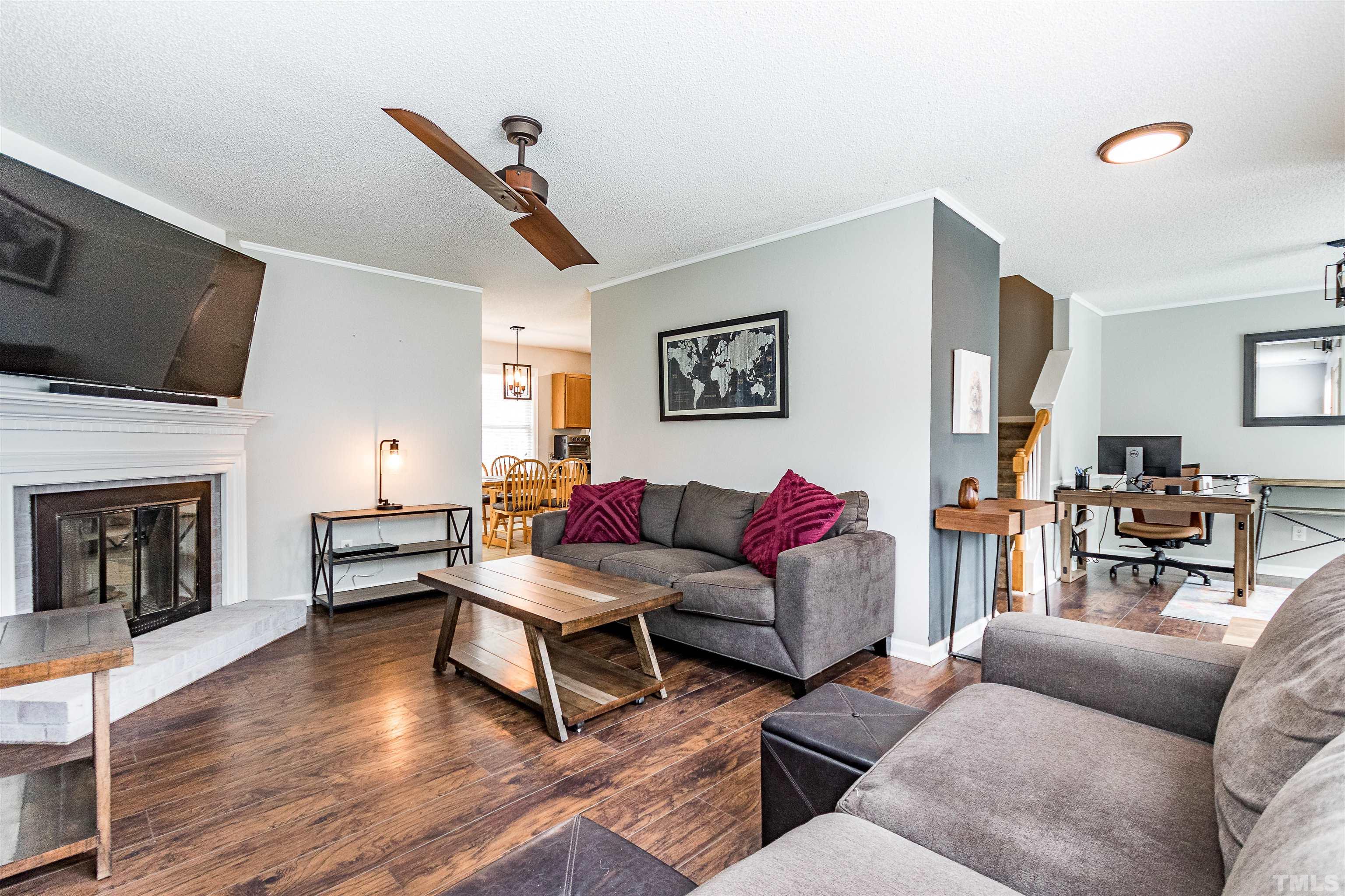 107 Ridge Lake Drive Apex, NC 27539 - Photo 5 of 27 a living room with furniture flat screen tv and a fireplace