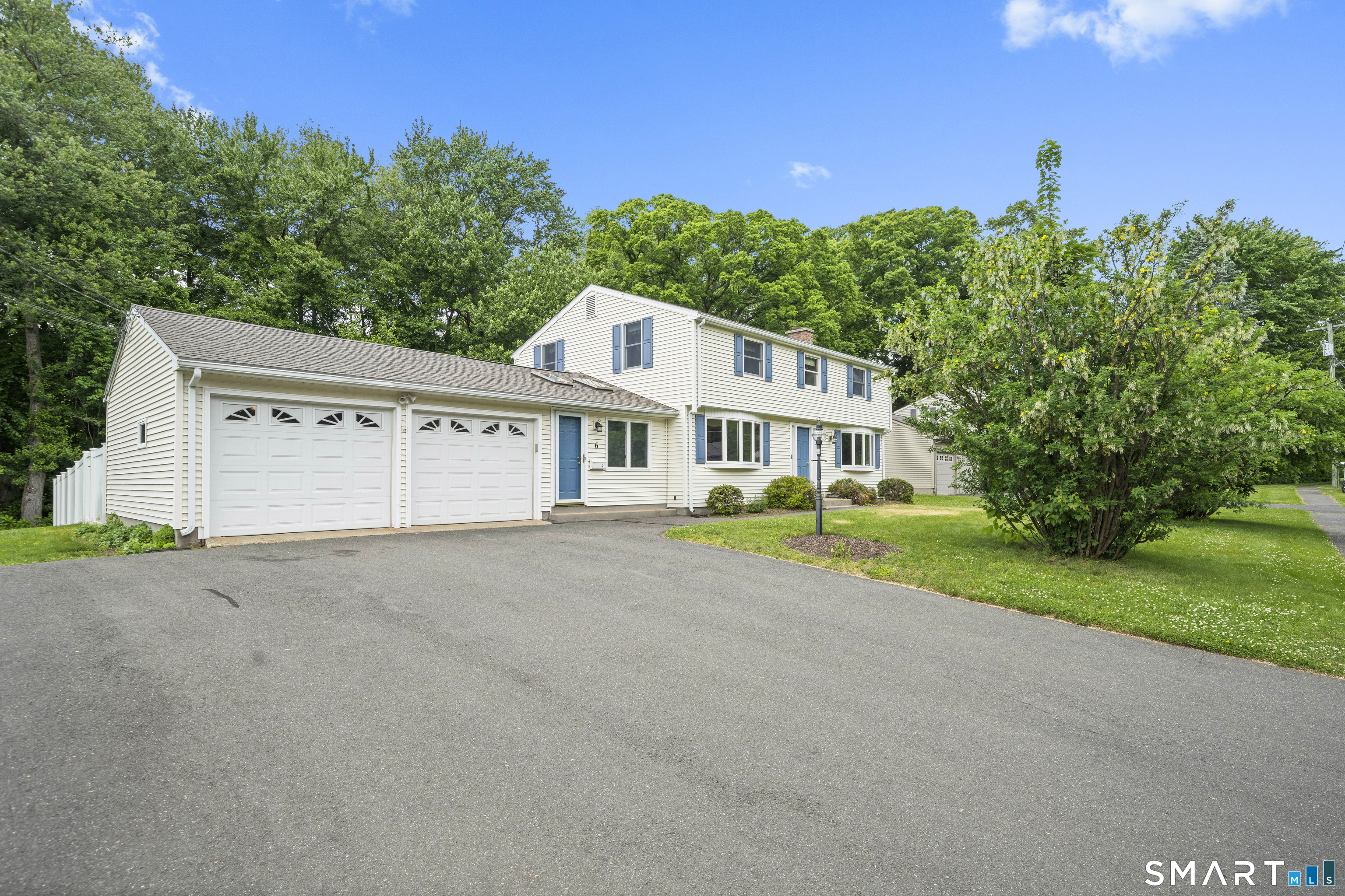 6 Cartier Road Enfield, CT 06082 - Photo 3 of 40 a front view of a house with a yard and garage