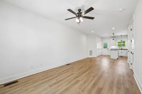 a view of kitchen and hall with wooden floor