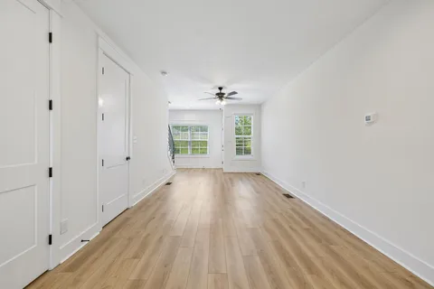 a room with a granite countertop sink and a wooden floor
