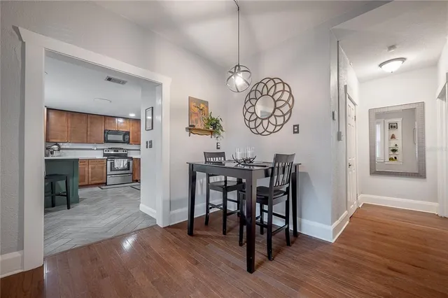 a view of a dining area with furniture and wooden floor