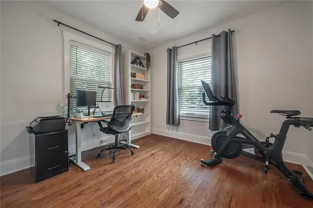 a view of a workspace with furniture and a window