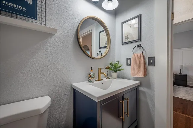 a bathroom with a toilet sink and mirror
