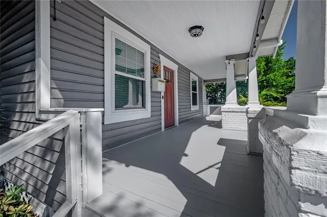 a view of a patio with couches table and chairs and potted plants