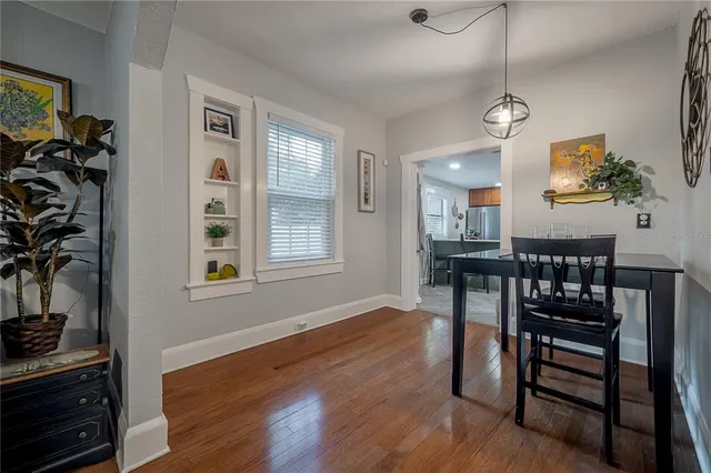 a view of a dining room with furniture and wooden floor
