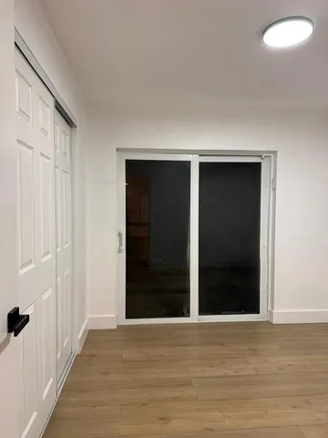 a view of a closet area with wooden floor