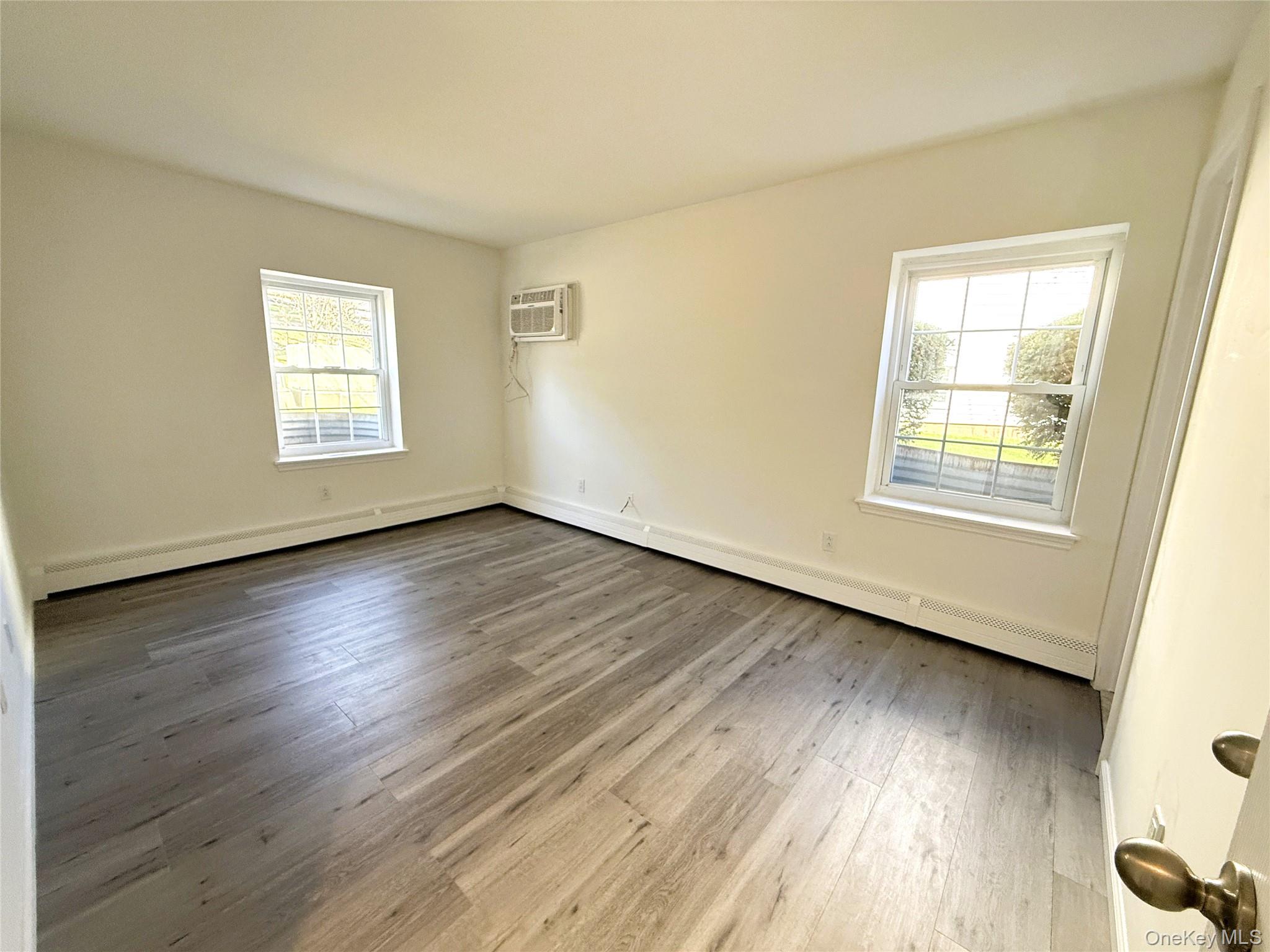 25 Lexington Hills Road, Unit 8 Harriman, NY 10926 - Photo 15 of 24 a view of an empty room with wooden floor and a window