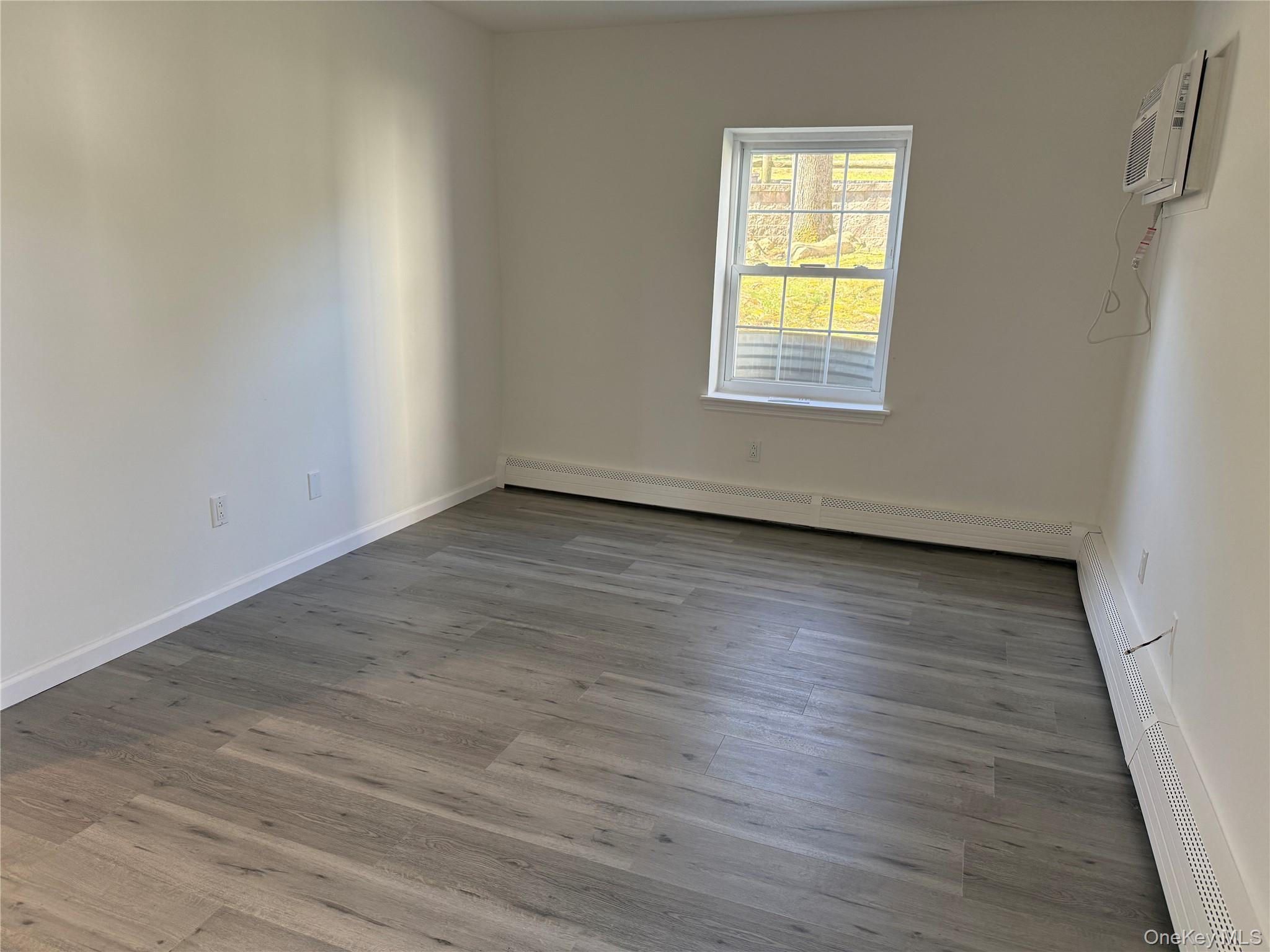 25 Lexington Hills Road, Unit 8 Harriman, NY 10926 - Photo 17 of 24 a view of an empty room with wooden floor and a window