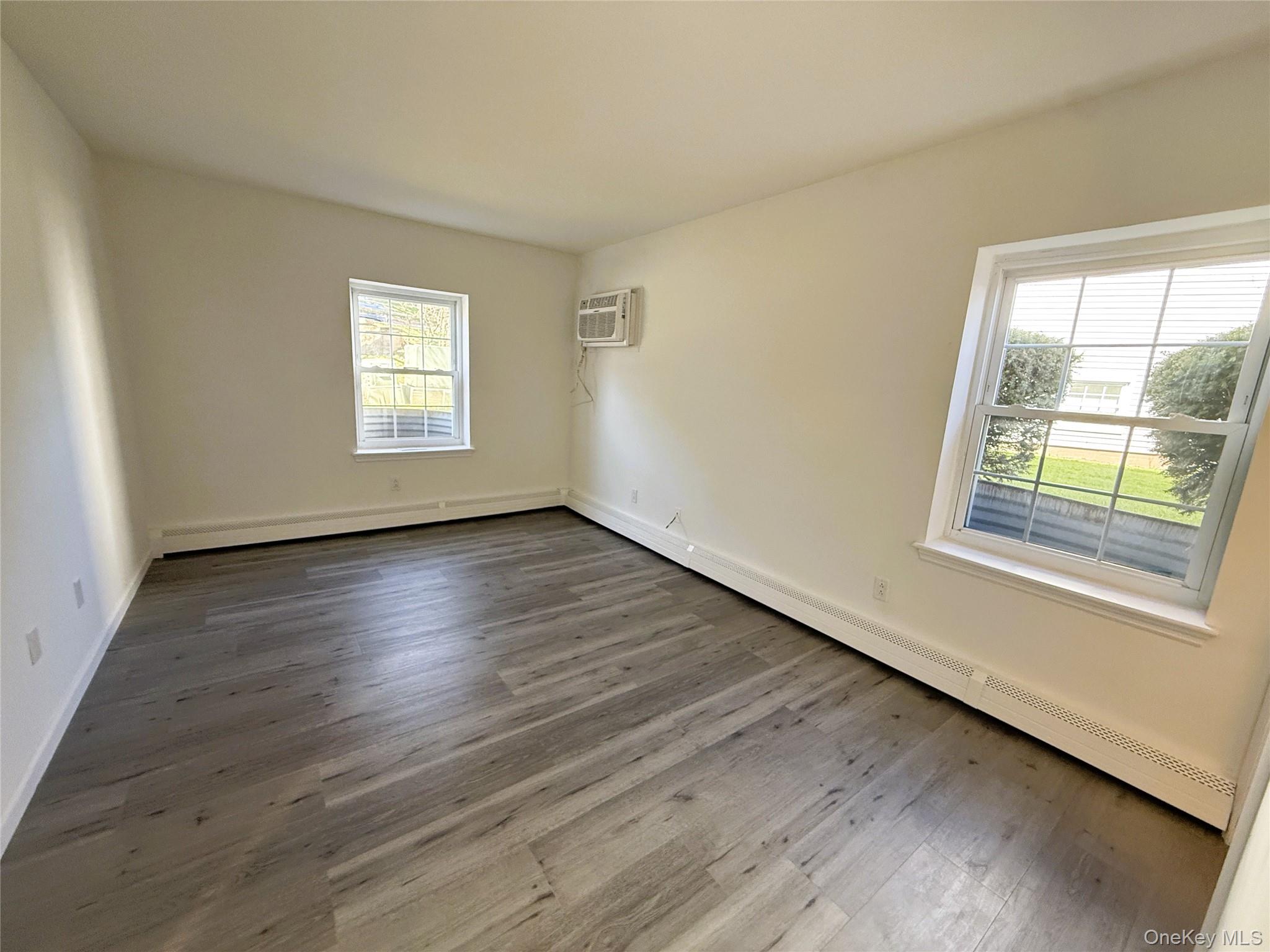 25 Lexington Hills Road, Unit 8 Harriman, NY 10926 - Photo 18 of 24 a view of an empty room with wooden floor and a window