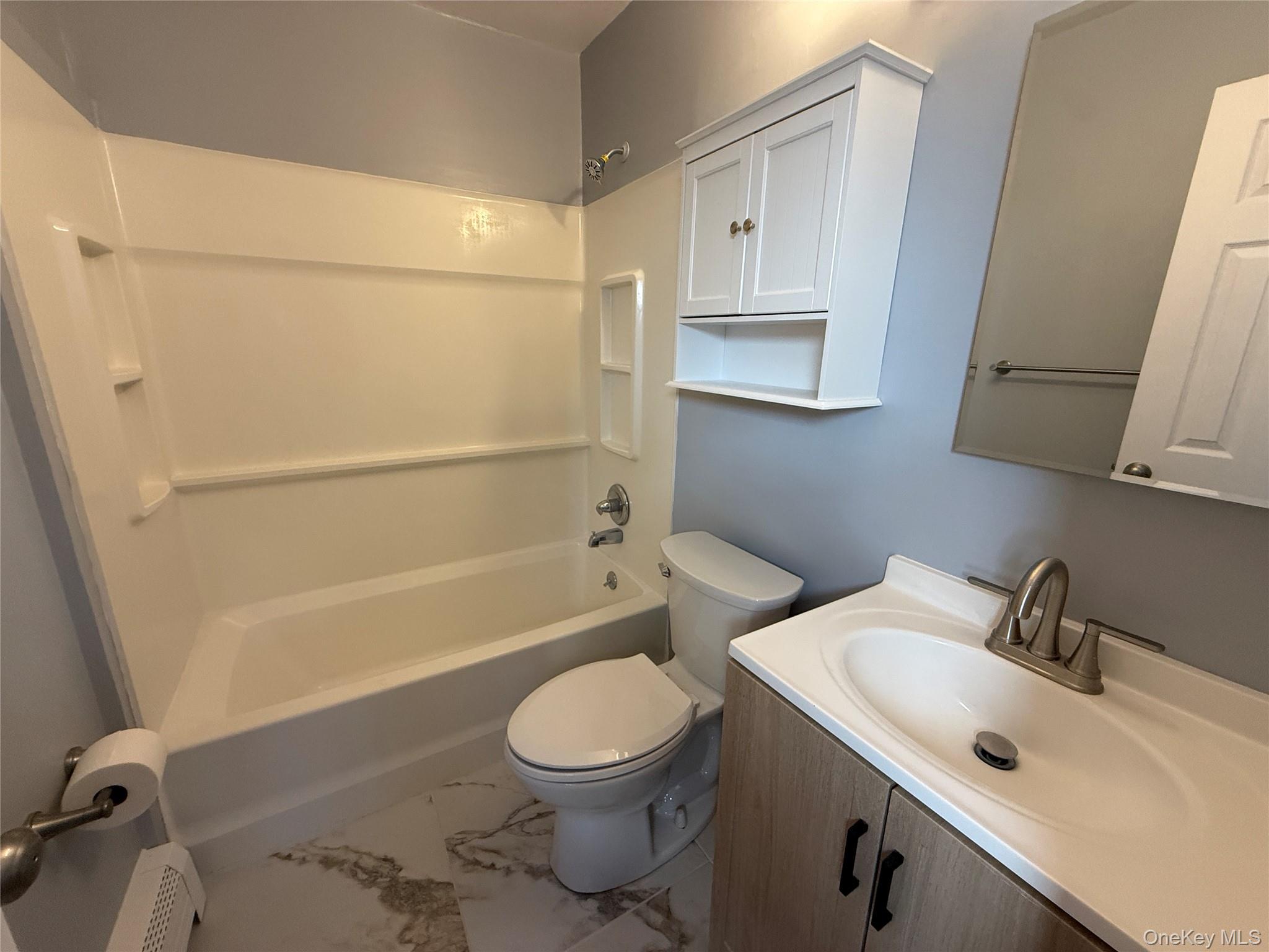 25 Lexington Hills Road, Unit 8 Harriman, NY 10926 - Photo 19 of 24 a bathroom with a sink a toilet and shower