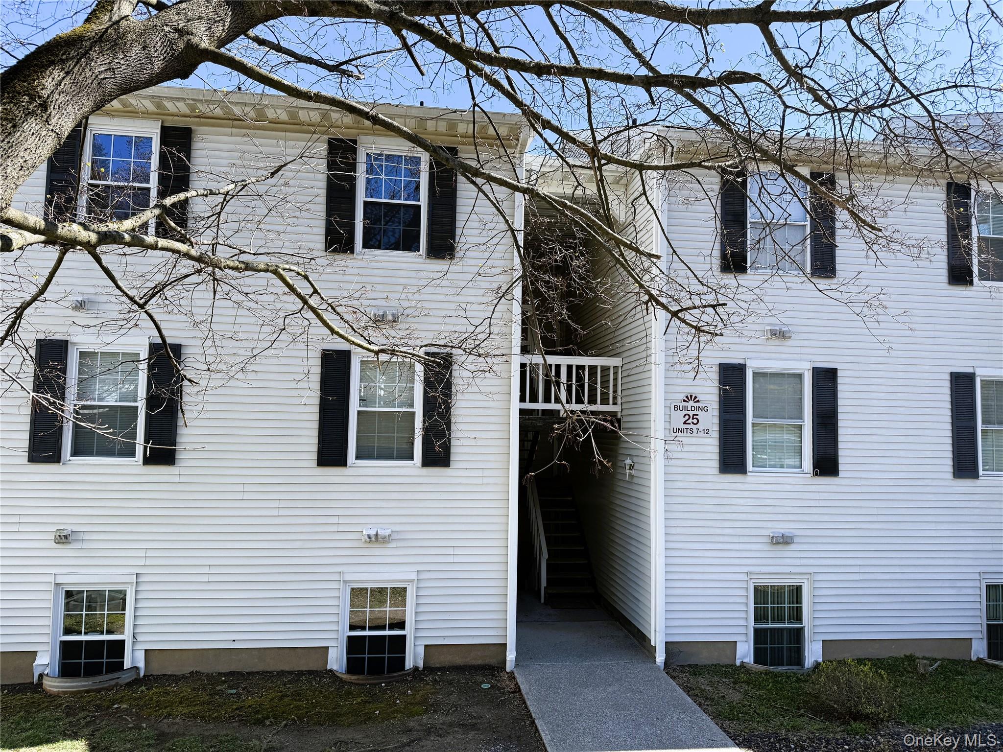 25 Lexington Hills Road, Unit 8 Harriman, NY 10926 - Photo 5 of 24 a view of a white house with large windows