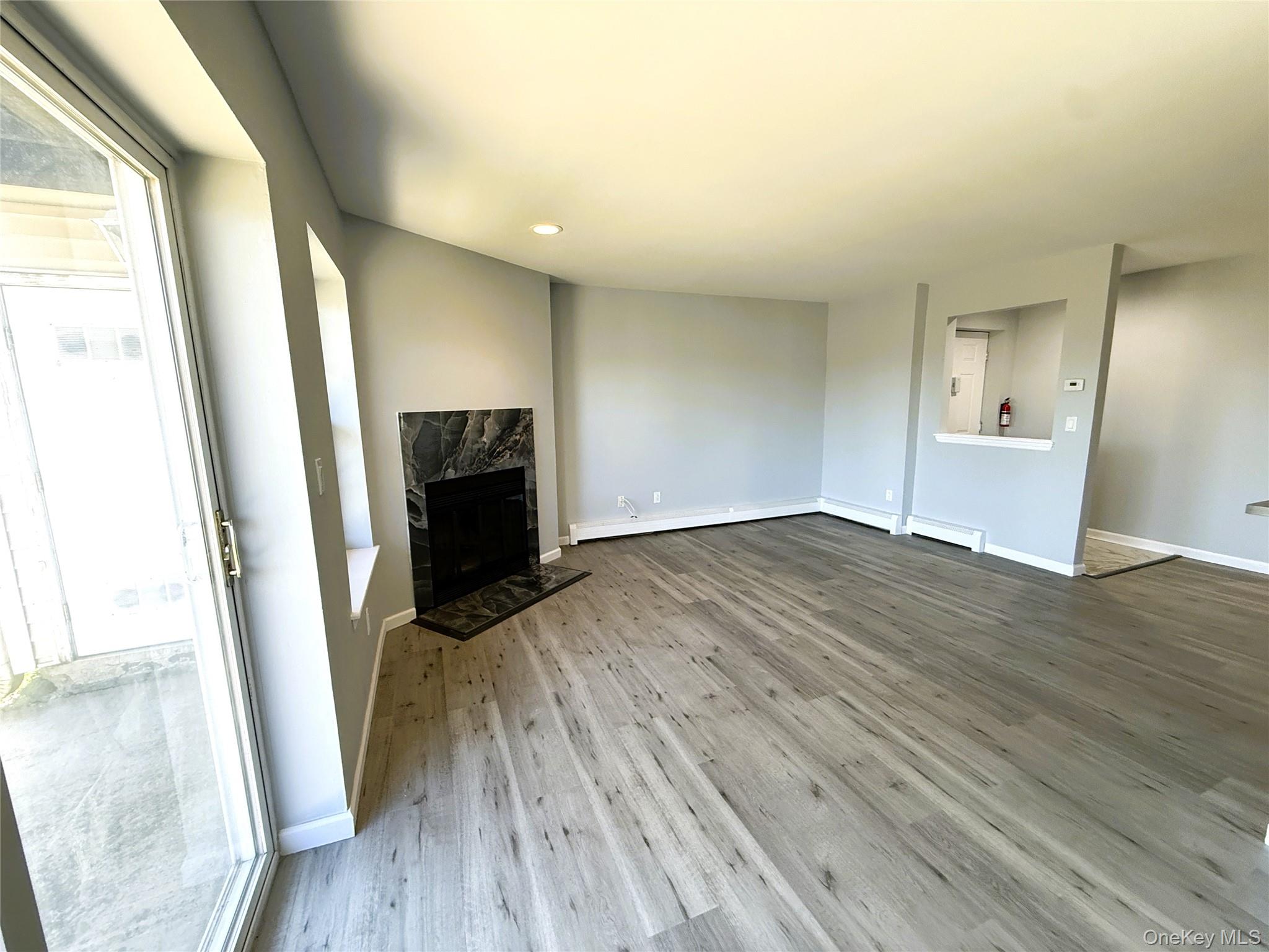 25 Lexington Hills Road, Unit 8 Harriman, NY 10926 - Photo 9 of 24 a view of an empty room with wooden floor and a window