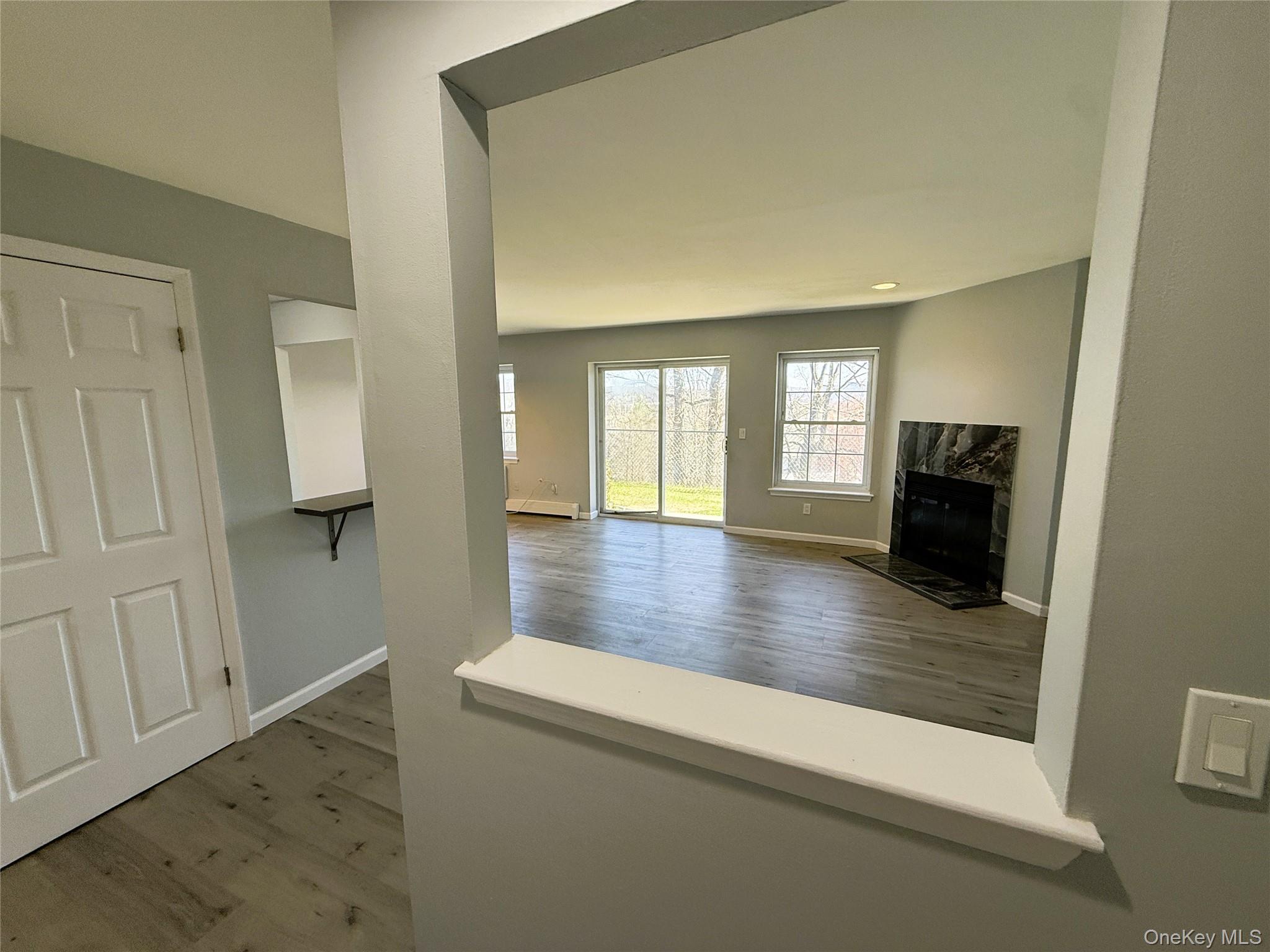 25 Lexington Hills Road, Unit 8 Harriman, NY 10926 - Photo 10 of 24 a view of a livingroom with wooden floor and a flat screen tv