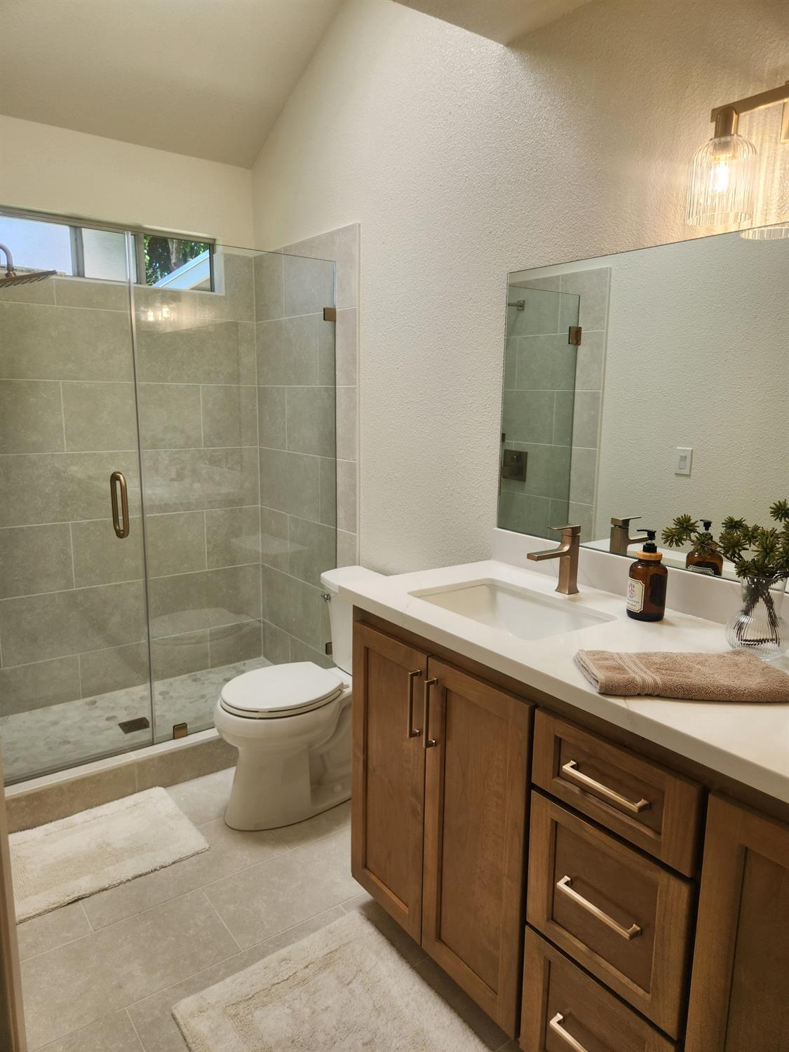 777 Jordanolo Drive Ripon, CA 95366 - Photo 32 of 61 a spacious bathroom with a granite countertop sink toilet a mirror and shower
