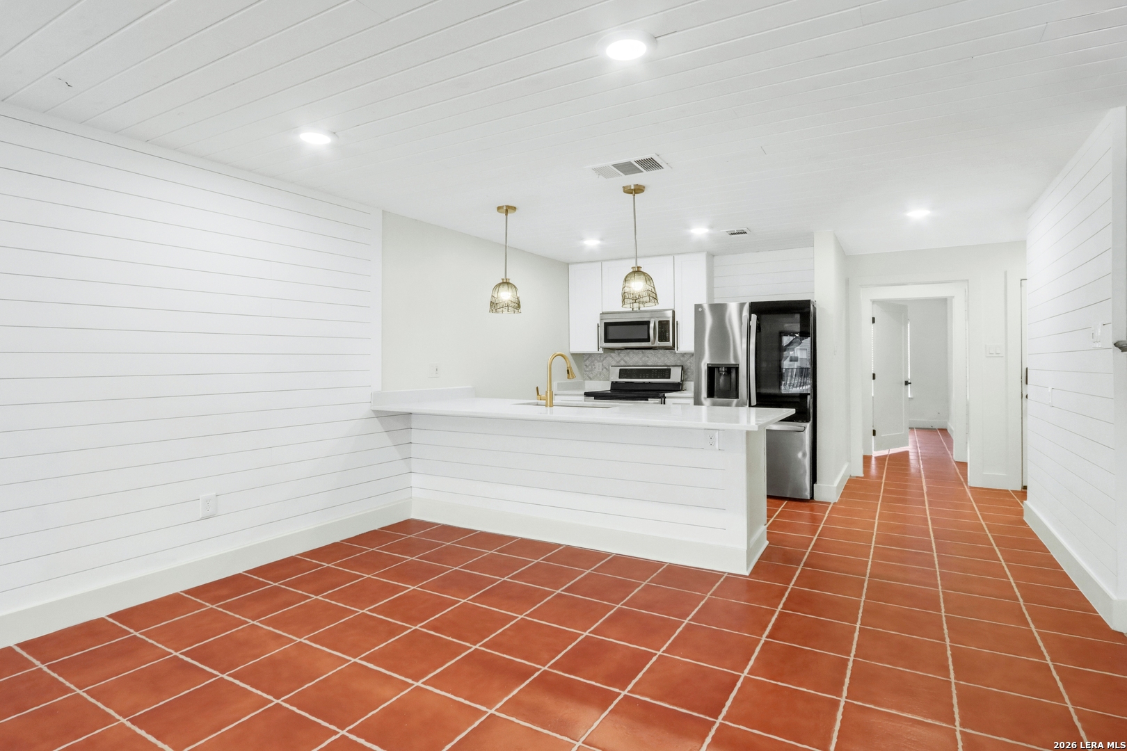 551 Terminal Loop Road, Unit B3 McQueeney, TX 78123 - Photo 14 of 18 a large white kitchen with stainless steel appliances a refrigerator a stove a microwave and a sink