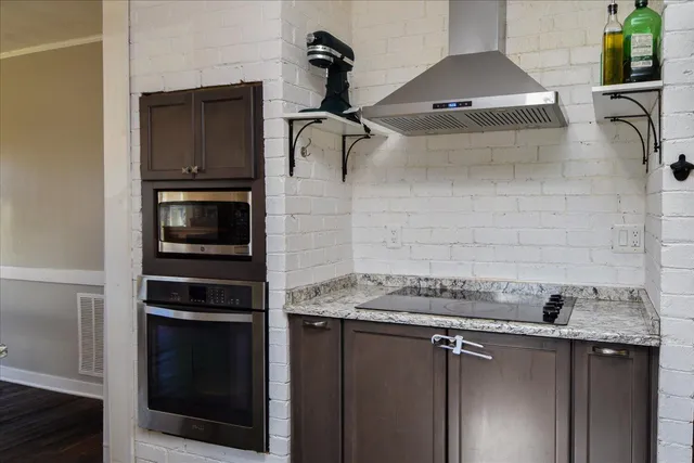 a view of an empty room and window with wooden floor
