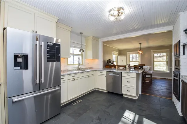 a kitchen with a refrigerator and a sink