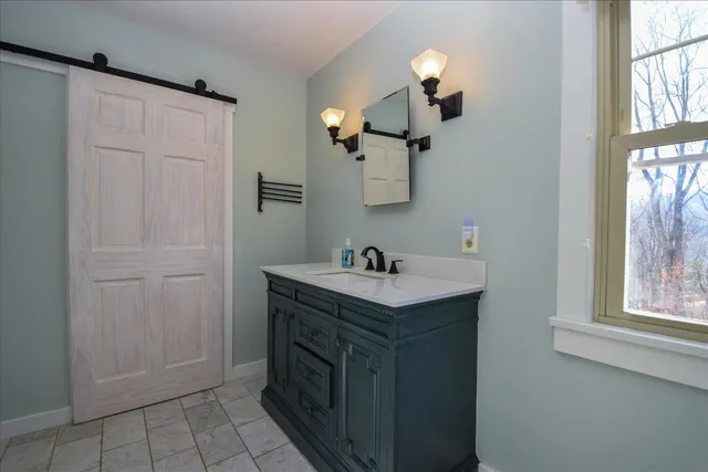 a bedroom with furniture and a window