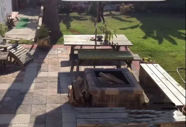 a view of a patio with table and chairs potted plants with wooden floor