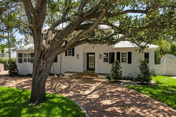 a front view of a house with a garden