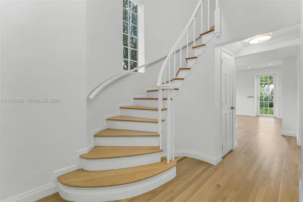 a view of entryway with wooden floor and stairs