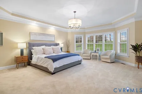 a spacious bedroom with a bed and a large window