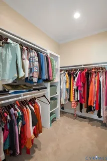 a view of walk in closet with clothes