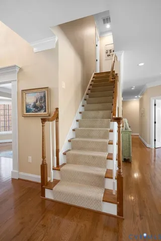 a view of entryway and hall with wooden floor