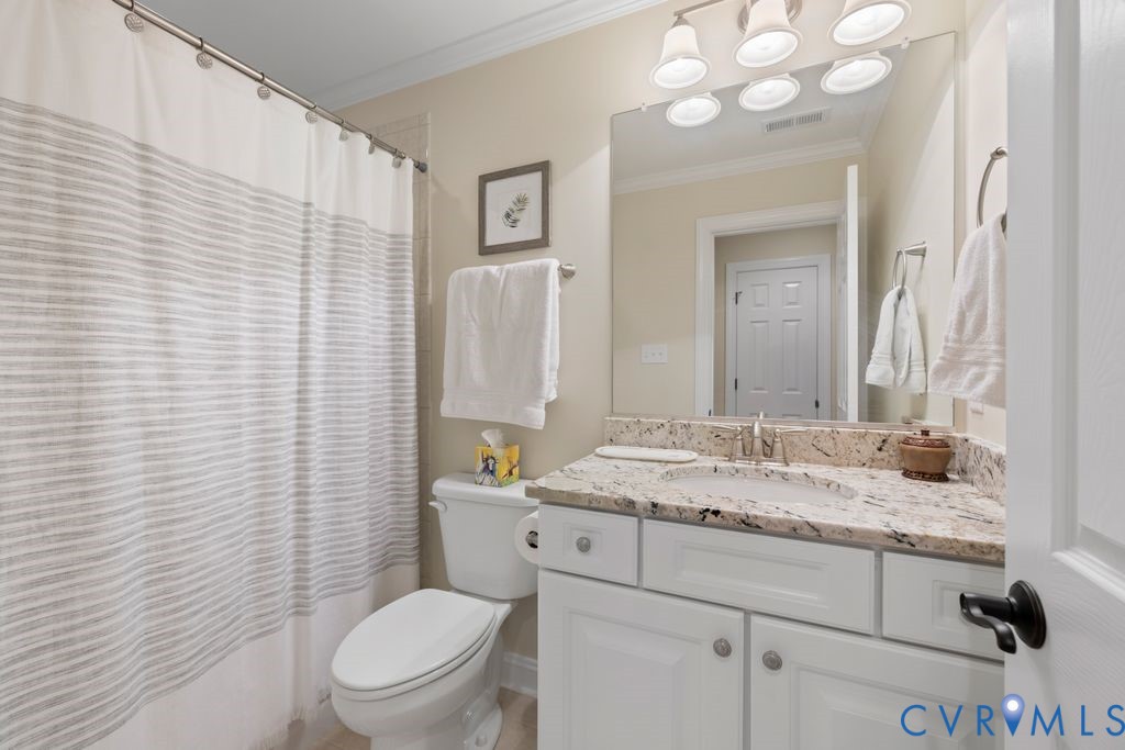 850 Elmslie Lane Manakin-Sabot, VA 23103 - Photo 36 of 48 a bathroom with a granite countertop toilet sink and mirror