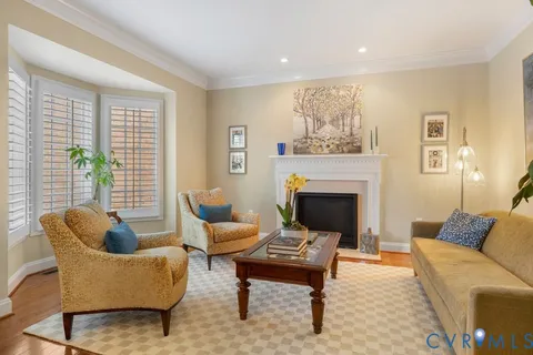 a living room with furniture a rug and a fireplace