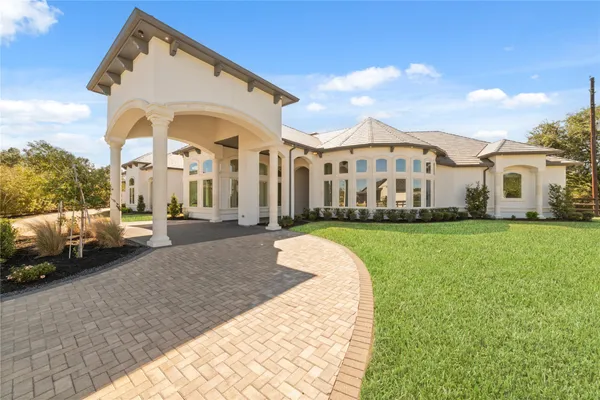 a front view of a house with a garden and pathway