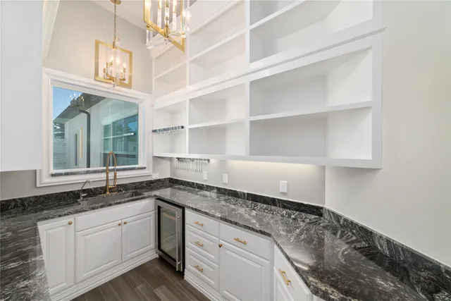 a bathroom with a granite countertop shower a mirror and a sink