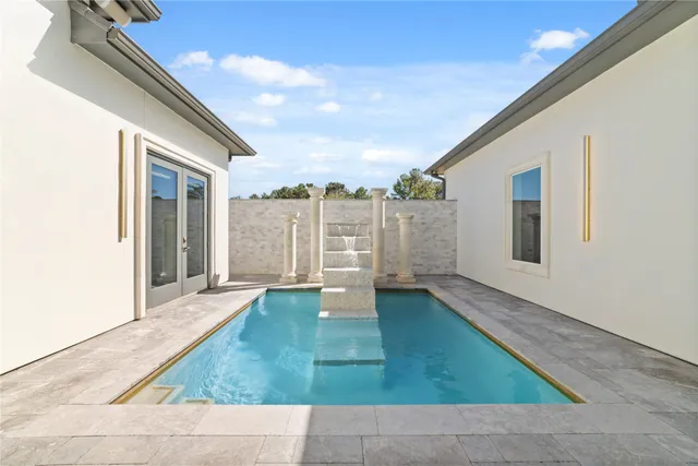 a bathroom with a granite countertop sink a toilet and a mirror