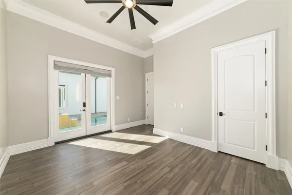 a view of an empty room with wooden floor