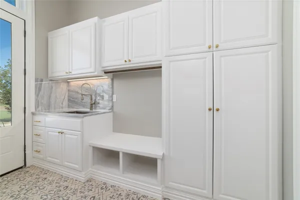 a kitchen with white cabinets and white appliances