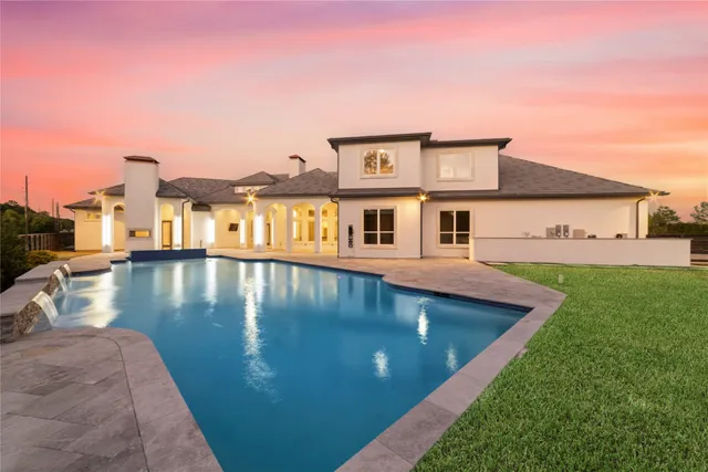 a view of a swimming pool with a yard