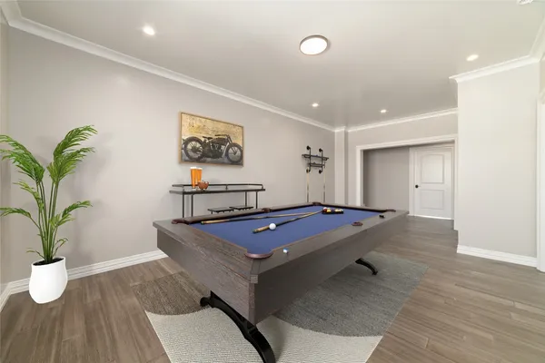 a living room with furniture a potted plant and wooden floor
