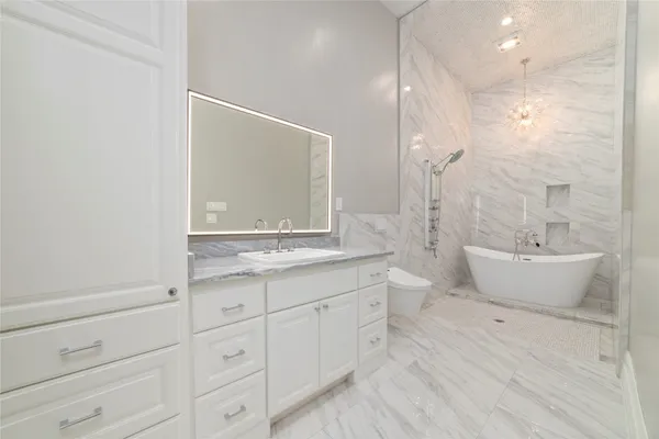 a spacious bathroom with a double vanity sink a mirror and a bathtub